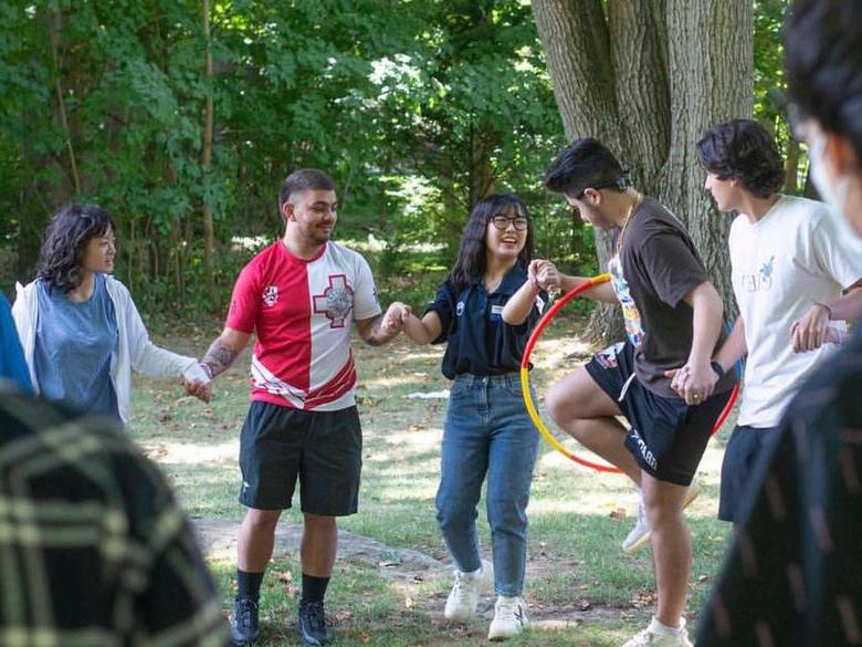 Penn State Abington (near Philadelphia) students holding hands and passing hula hoop 